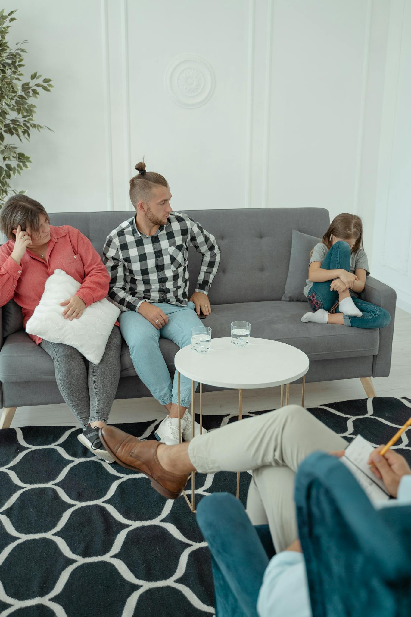 A candid moment during a family therapy session with parents and a child engaging in discussion.